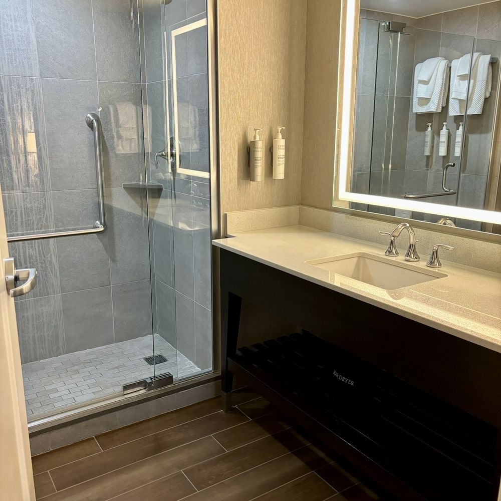 Embassy Suites by Hilton Springfield - Shower and bathroom sink - Hotels Near Me - Springfield, Virginia Embassy Suites by Hilton Springfield - Shower and bathroom sink - Hotels Near Me - Springfield, Virginia