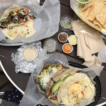 Tacodeli - Assortment of breakfast tacos, including queso and guac - Breakfast & Brunch Near Me - Austin, Texas Tacodeli - Assortment of breakfast tacos, including queso and guac - Breakfast & Brunch Near Me - Austin, Texas