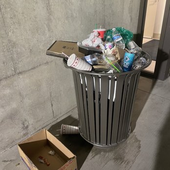 The Ryan Apartments - Overflowing garbage cans in the garage is typical - Apartments Near Me - Phoenix, Arizona