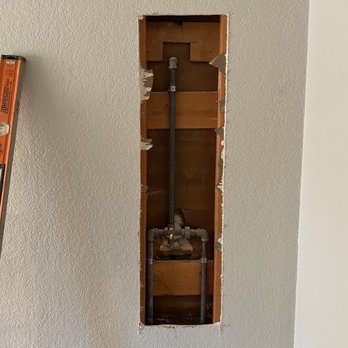 JS & Sons Plumbing - Wall cut to access pipes - very clean cut - Plumbing Near Me