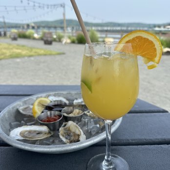 Barnacle Bill's - a plate of oysters and a glass of orange juice - Bars Near Me - Rumson, New Jersey
