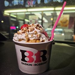 Baskin-Robbins 31 Ice Cream Stores - 2 scoop sundae: mint chip and praline ice cream with peanut butter sauce, whipped cream, nuts, and a cherry.