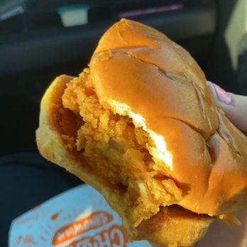 Popeyes Louisiana Kitchen - a hand holding a sandwich - Chicken Wings Near Me - Modesto, California Popeyes Louisiana Kitchen - a hand holding a sandwich - Chicken Wings Near Me - Modesto, California