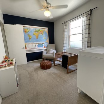 Castle Floors - a bedroom with a map on the wall - Carpeting Near Me - Mesa, Arizona