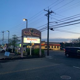 Walgreens - a car driving past a restaurant - outside, shows storefront - Cosmetics & Beauty Supply Near Me - Oceanside, New York