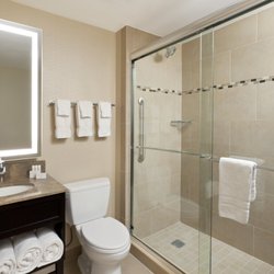 Fairfield Inn & Suites New York Midtown Manhattan/Penn Station - Enjoy this guest bathroom offering modern décor and a large walk-in shower perfect to refresh and rejuvenate. The large vanity area and well
