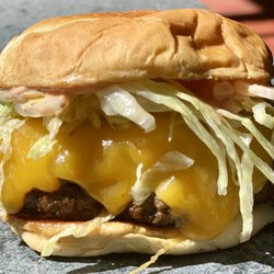 1/2 lb fresh beef patty, thick slice of Tillamook cheddar, shredded lettuce, onions and special sauce on a fluffy brioche bun.