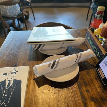 Finney's Crafthouse - Stevenson Ranch - A nice array of seasonings/condiments, large linen napkins, and a fun picture of Finney(?) on the giant menu. - New American Near Me - Stevenson Ranch, California