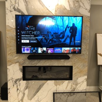 HomeTech Installations - Tv mounting above fireplace on Marble - Home Theatre Installation Near Me HomeTech Installations - Tv mounting above fireplace on Marble - Home Theatre Installation Near Me