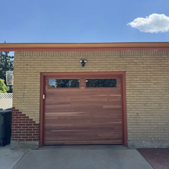 Solid Choice Garage door - Wood tone steel garage door with top panel windows. - Garage Door Services Near Me Solid Choice Garage door - Wood tone steel garage door with top panel windows. - Garage Door Services Near Me