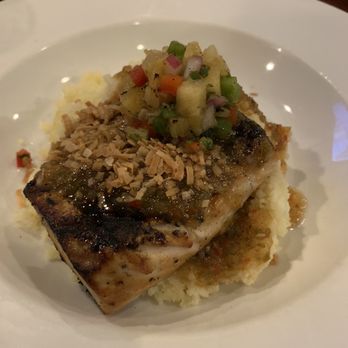 Hemingway's Tavern - Jerk mahi with pineapple salsa, toasted coconut flakes, served over pineapple couscous - New American Near Me - Melbourne, Florida Hemingway's Tavern - Jerk mahi with pineapple salsa, toasted coconut flakes, served over pineapple couscous - New American Near Me - Melbourne, Florida