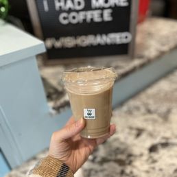 a hand holding a cup of coffee a hand holding a cup of coffee