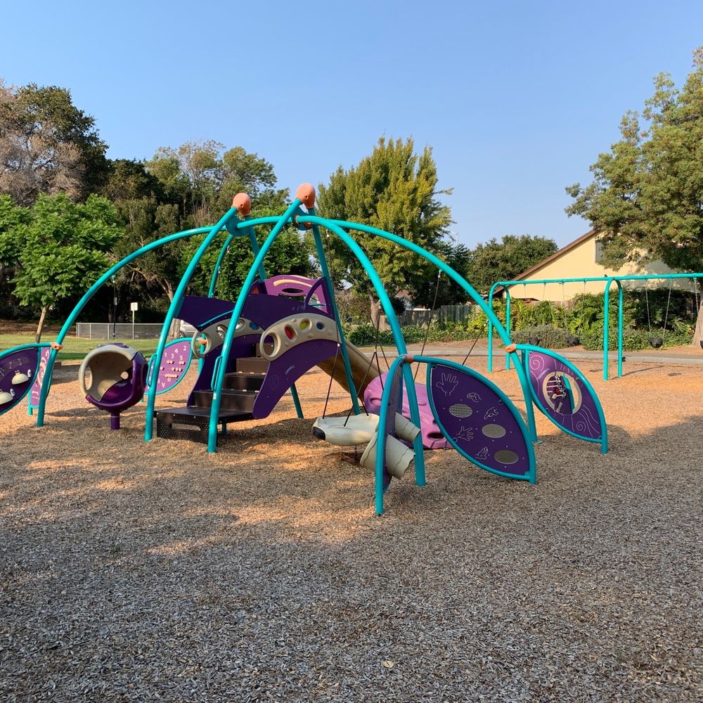 Casa Verde Park - Play structure, swings, and some things to climb on. One bench table and seat with trash can nearby - Parks Near Me - Union City, California Casa Verde Park - Play structure, swings, and some things to climb on. One bench table and seat with trash can nearby - Parks Near Me - Union City, California
