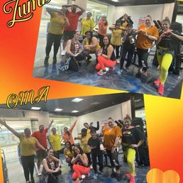 Zumba at Open Mat with ZIN Felicia - A group of people, dressed in bright and comfortable workout clothing, are gathered inside a fitness studio at Open Mat Academy in Tracy, CA. They are posing for photos, some making heart shapes with their hands and others raising their arms in celebration. The background shows exercise equipment and a mirrored wall, indicating a fitness or dance class setting. The image is decorated with a vibrant orange and yellow border, with the words "Zumba" and "Tracy" written in stylized fonts, emphasizing the activity and location.