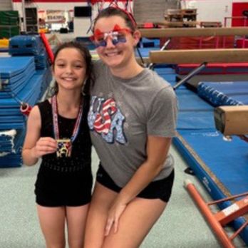 Sunburst Gymnastics Academy - Coach Bri posing for photos after Class Competition - Gymnastics Near Me - San Antonio, Texas Sunburst Gymnastics Academy - Coach Bri posing for photos after Class Competition - Gymnastics Near Me - San Antonio, Texas
