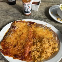Cheese enchiladas with pinto beans and rice. Cheese enchiladas with pinto beans and rice.