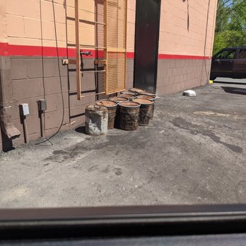 Popeyes Louisiana Kitchen - Oil containers sitting outside and a loose wire from the roof. - Fast Food Near Me - Manassas, Virginia