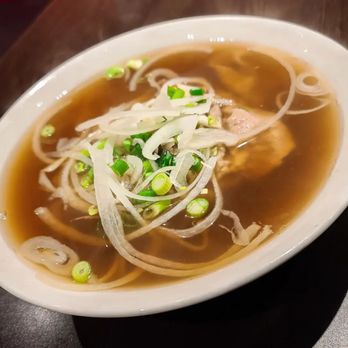 Pho Lam - a bowl of soup on a table - Vietnamese Near Me - Montreal, Quebec