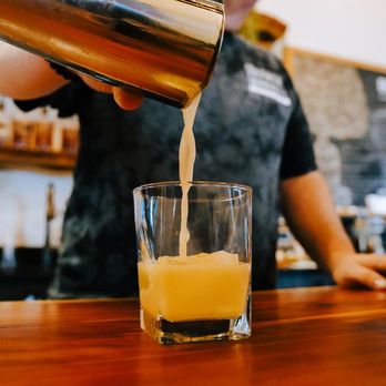 Branch & Barrel Distilling - a bartender pouring orange juice - Distilleries Near Me - Centennial, Colorado