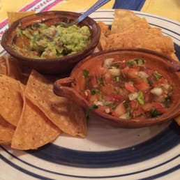 Large appetizer plate of chips, salsa and guacamole.