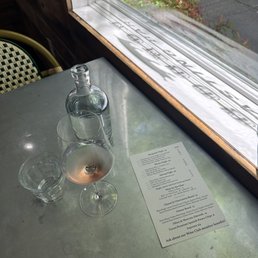Solo tasting at a cool table with a snapshot of the day's menu