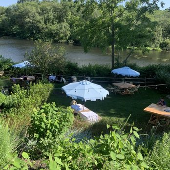 Farm Country Kitchen - Two empty tables and that's just one side. One person sitting at a table for 8. - American Near Me - Riverhead, New York