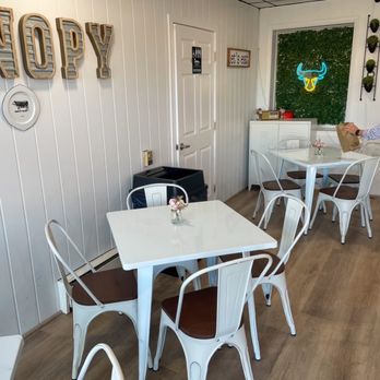 The Canopy - Clean 24-seat dining area with minimalist wall decorations, and the clean rest-room on the left - Barbeque Near Me - Ellicott City, Maryland