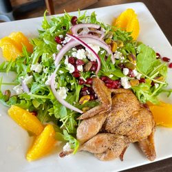 259 Brantley's Bistro - Pomegranate-pistachio salad with arugula, red onion, goat cheese, orange segments, honey citrus dressing, and a grilled quail