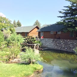 Our 8-year old son on the rock wall near the waterwheel, contemplating the fish below Our 8-year old son on the rock wall near the waterwheel, contemplating the fish below
