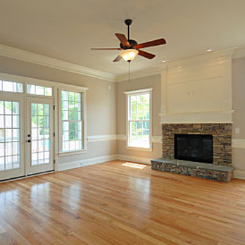 Tomlinson Builders - empty living room with fireplace and french doors - General Contractors Near Me Tomlinson Builders - empty living room with fireplace and french doors - General Contractors Near Me