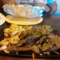 El Molcajete - "Steak and shrimp fajitas for 2". Comes w/ 3 tortillas each, and a PLATE full of sides (Rice, beans, Pico, lettuce, guac...