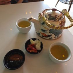 Tea, side condiments, pickled garlic, pickled bird peppers
