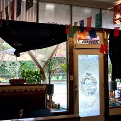 Casa Familia - Cozy dining area (a few tables outside on sidewalk as well)