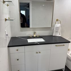 World Kitchen Designs - Custom vanity with drawers and built in laundry basket.