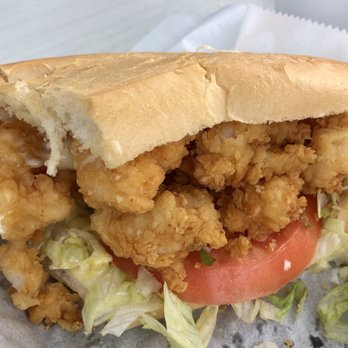 Le Cafe - a closeup of a sandwich with lettuce and tomato - Seafood Near Me - Breaux Bridge, Louisiana