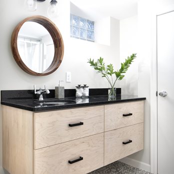 Castle Building & Remodeling: NE Mpls - a bathroom vanity with a round mirror - General Contractors Near Me - Minneapolis, Minnesota Castle Building & Remodeling: NE Mpls - a bathroom vanity with a round mirror - General Contractors Near Me - Minneapolis, Minnesota