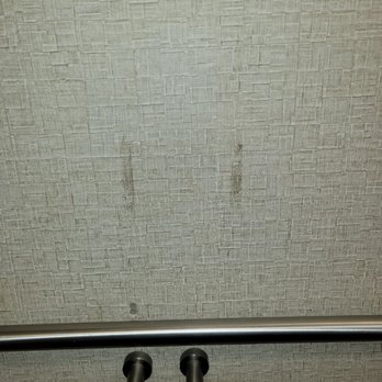Comfort Suites - smeared stains on walls next to toilet - Hotels Near Me - Roswell, New Mexico