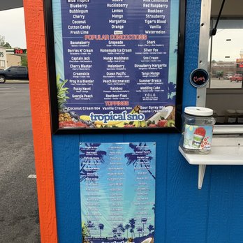 Tropical Sno - a menu on a blue wall - Shaved Ice Near Me - Jonesboro, Arkansas