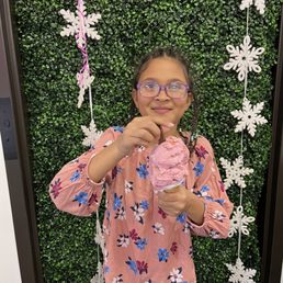a girl holding a cupcake a girl holding a cupcake