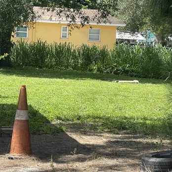 Sunrise Landscaping - an orange traffic cone in front of a yellow house - Landscaping Near Me Sunrise Landscaping - an orange traffic cone in front of a yellow house - Landscaping Near Me