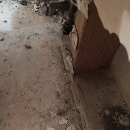 The mess left behind along with the wall they tore into without explaining that it wasn't included in the repair.