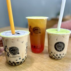Brown sugar boba and green tea with strawberry popping boba and lemon