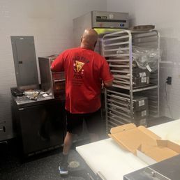 Laron pulling out a hot pizza. Laron pulling out a hot pizza.