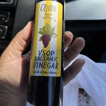 Olivier Napa Valley - a hand holding a bottle of wine - Specialty Food Near Me - St Helena, California Olivier Napa Valley - a hand holding a bottle of wine - Specialty Food Near Me - St Helena, California