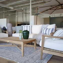 Custom Fireplace Patio & Bbq - Teak outdoor patio set in our new showroom off Johnson Drive.