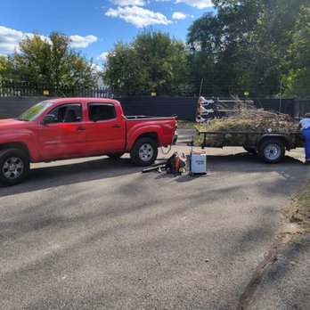 Inspiring Lawncare - a red pickup truck pulling a load of hay - Lawn Services Near Me