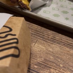 Big Shack and regular Shack burgers with fries. Big Shack and regular Shack burgers with fries.
