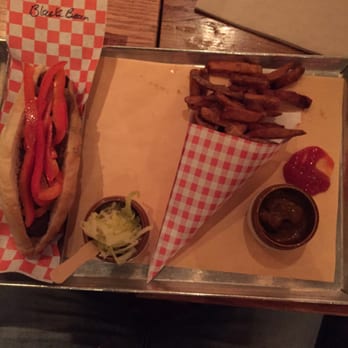 Wvrst - Black bean Sausage x sautéed onions x sweet tomatoes with a side of fries x tomato chili paste - German Near Me - Toronto, Ontario Wvrst - Black bean Sausage x sautéed onions x sweet tomatoes with a side of fries x tomato chili paste - German Near Me - Toronto, Ontario