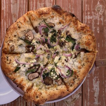Tully's - Go Green specialty pizza (small): pesto, red onion, mushrooms, artichokes, spinach, basil, mozzarella, and goat cheese - Bars Near Me - Crested Butte, Colorado Tully's - Go Green specialty pizza (small): pesto, red onion, mushrooms, artichokes, spinach, basil, mozzarella, and goat cheese - Bars Near Me - Crested Butte, Colorado