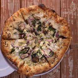Tully's - Go Green specialty pizza (small): pesto, red onion, mushrooms, artichokes, spinach, basil, mozzarella, and goat cheese